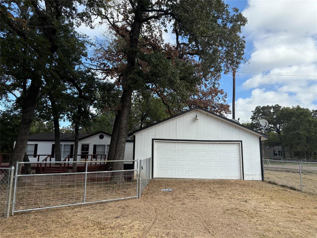 a white house that has a tree in front of it