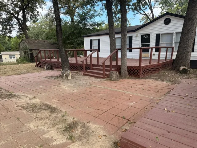 a view of a house with backyard and furniture