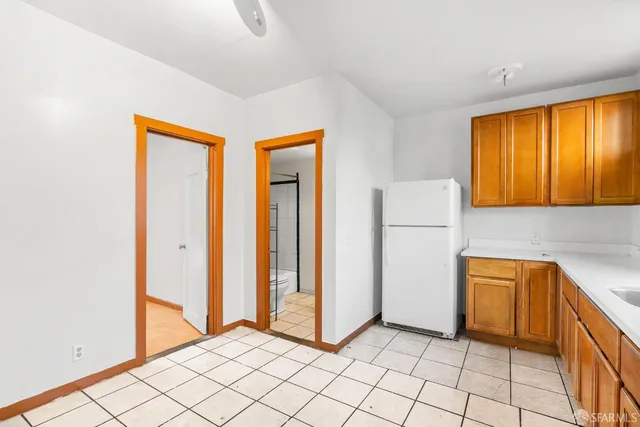 a bathroom with a granite countertop sink a toilet and bathtub