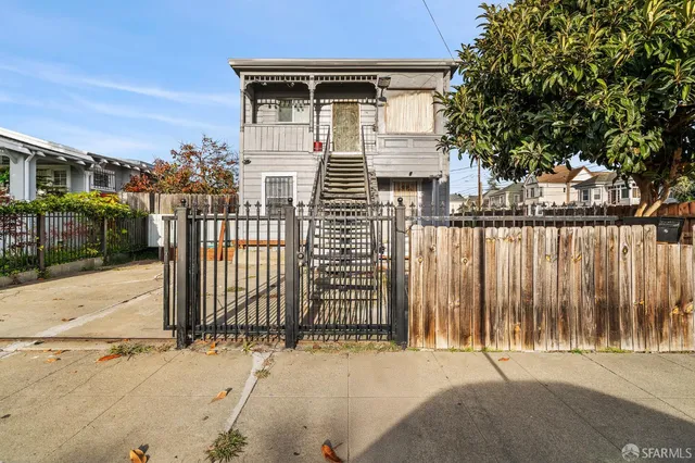 a front view of a house with a wooden fence