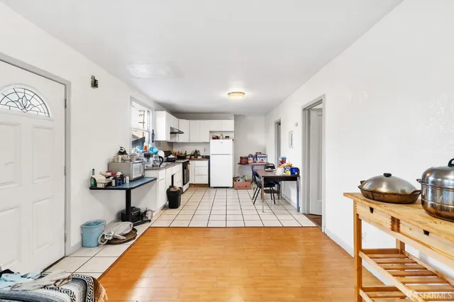 a kitchen with a refrigerator and a sink