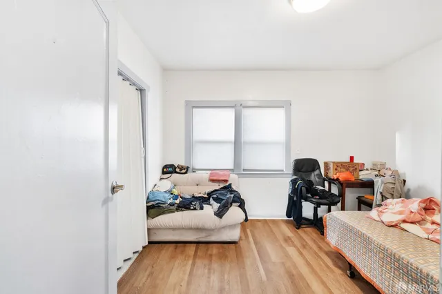 a living room with furniture and a bed