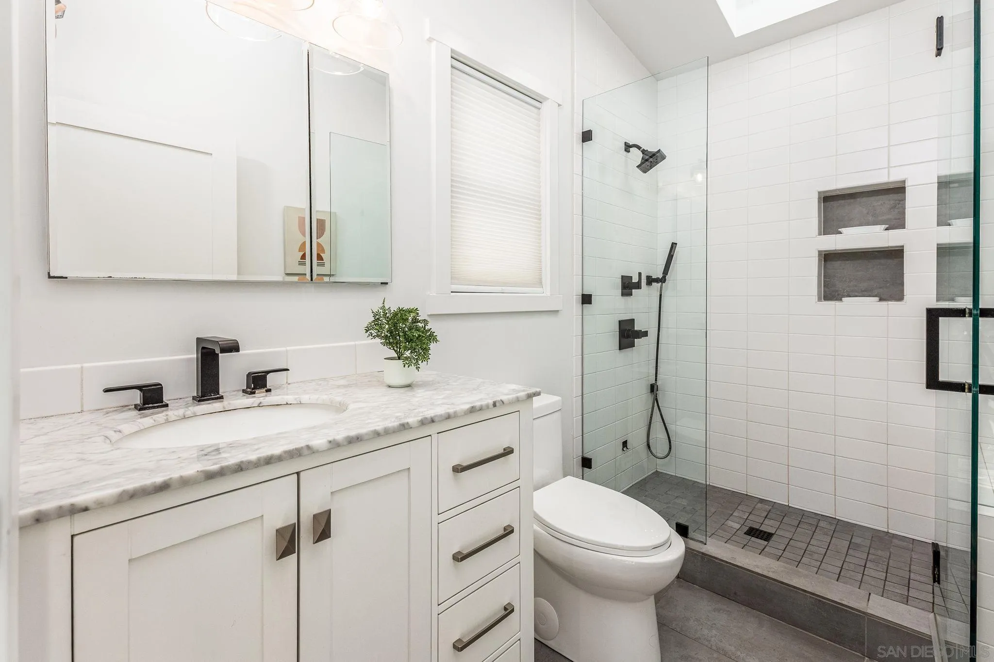 2335 Ivy Road Oceanside, CA 92054 - Photo 48 of 53 a bathroom with a granite countertop toilet sink and mirror