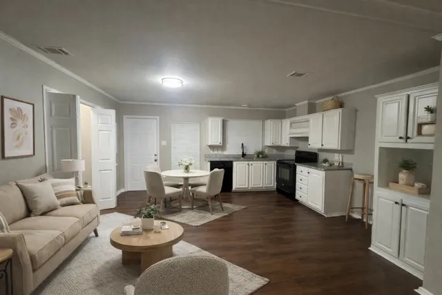 a living room with furniture and view of kitchen