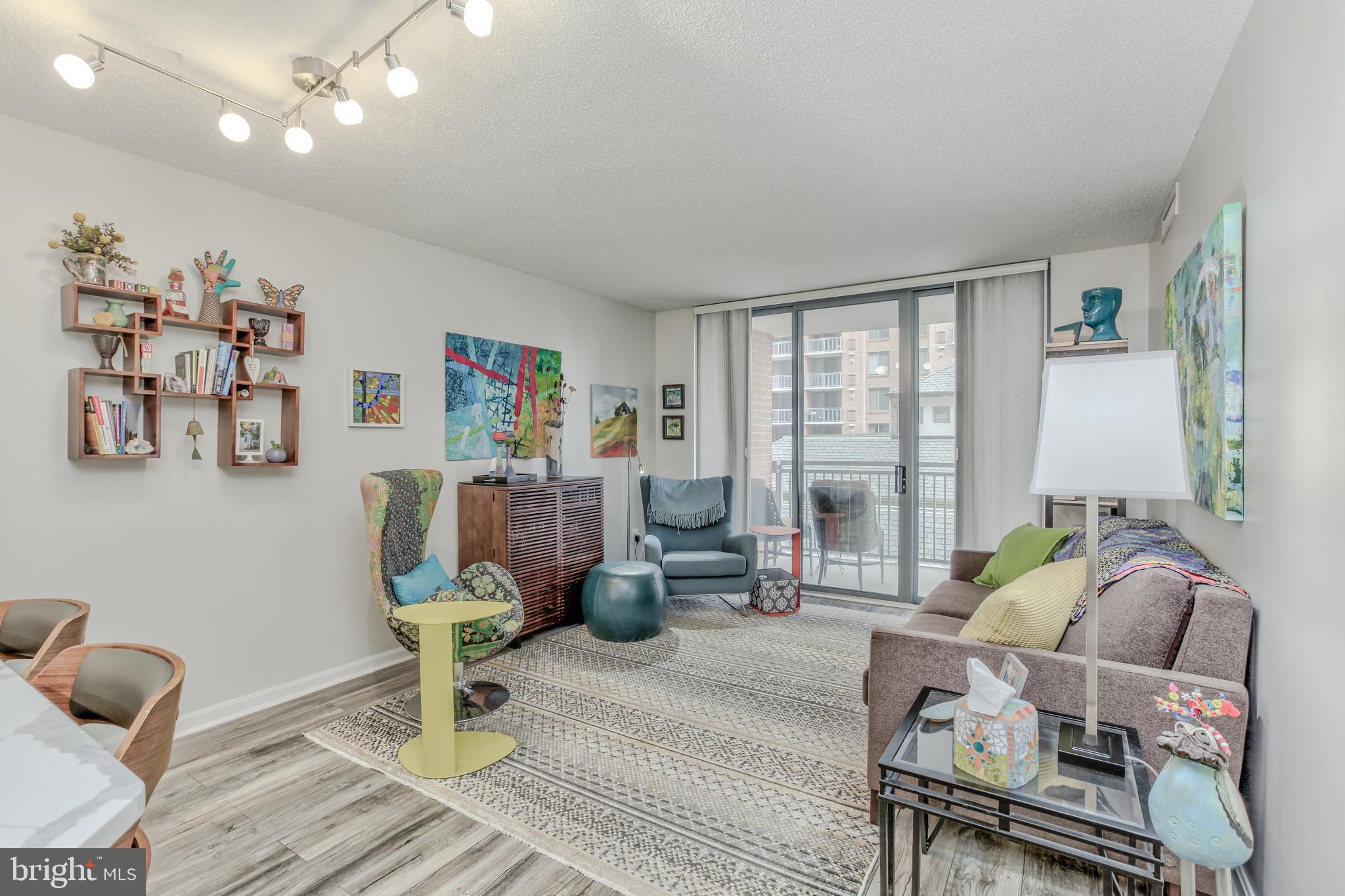 11710 Old Georgetown Road, Unit 422 North Bethesda, MD 20852 - Photo 12 of 28 a living room with furniture and a large window