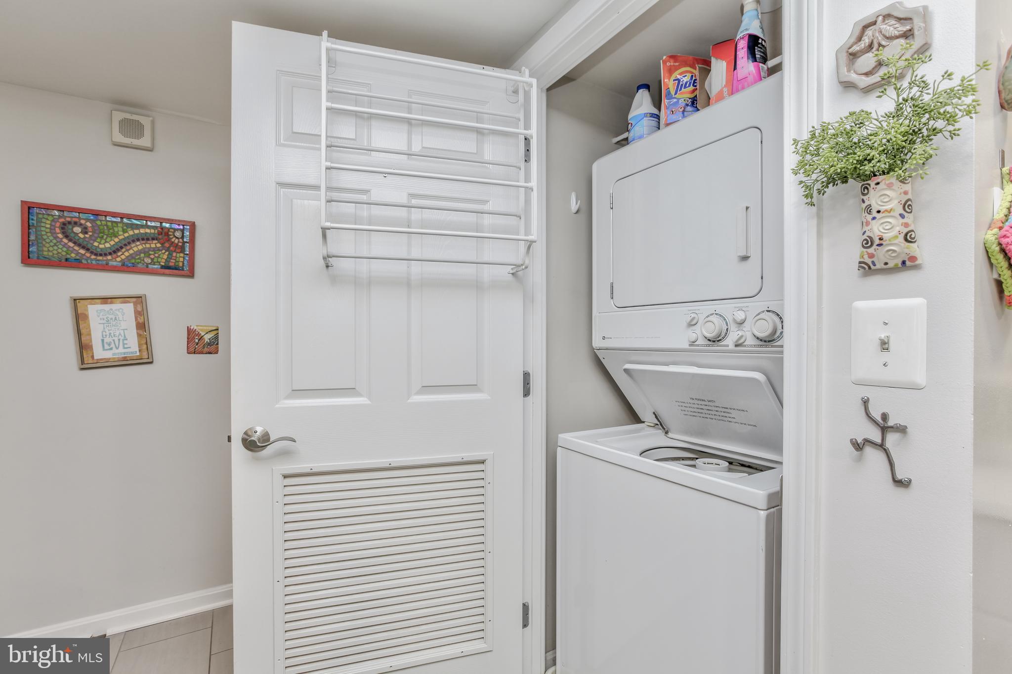 11710 Old Georgetown Road, Unit 422 North Bethesda, MD 20852 - Photo 13 of 28 a utility room with a refrigerator a washer and dryer