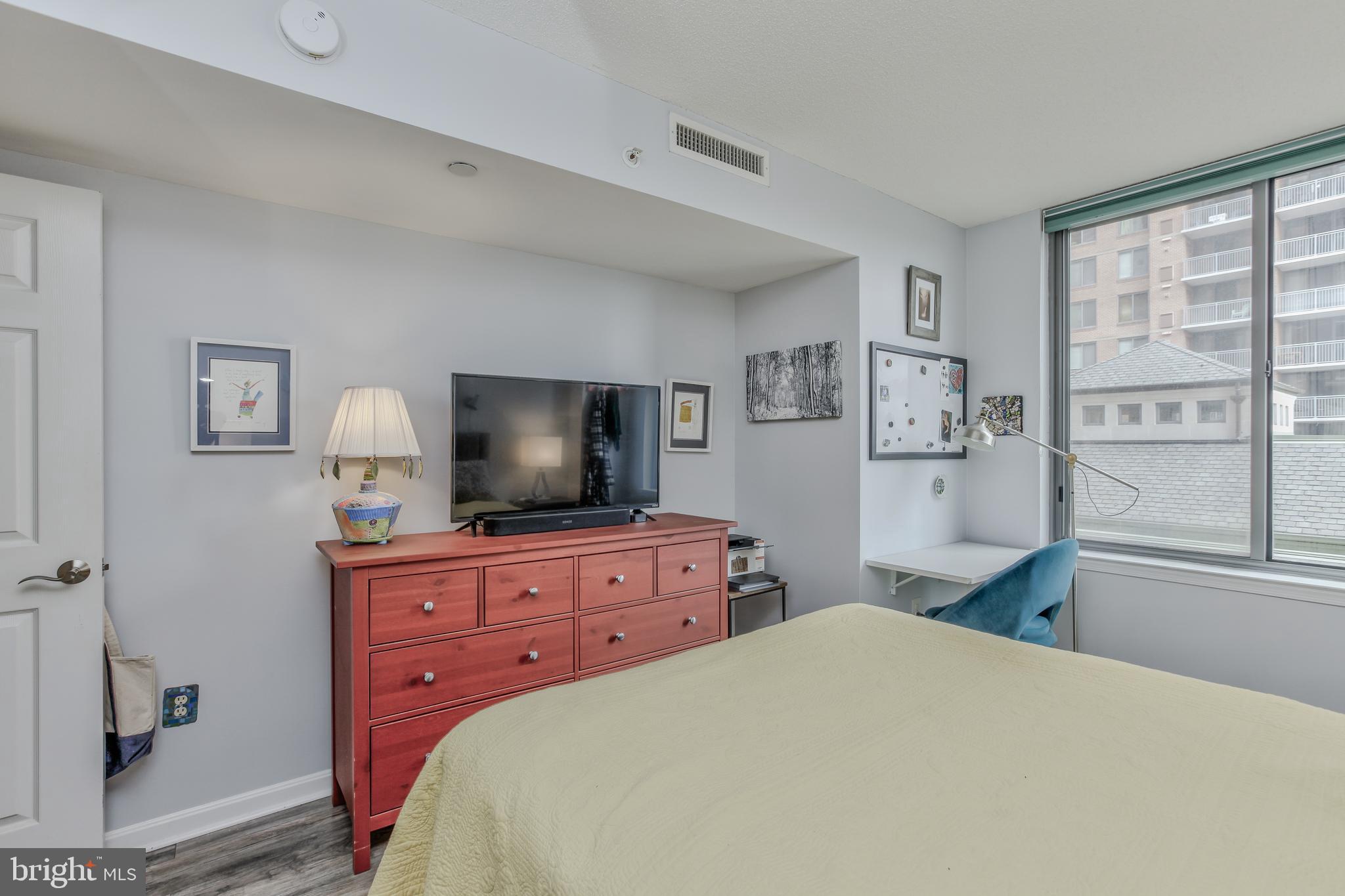 11710 Old Georgetown Road, Unit 422 North Bethesda, MD 20852 - Photo 15 of 28 a bedroom with a bed and a flat screen tv