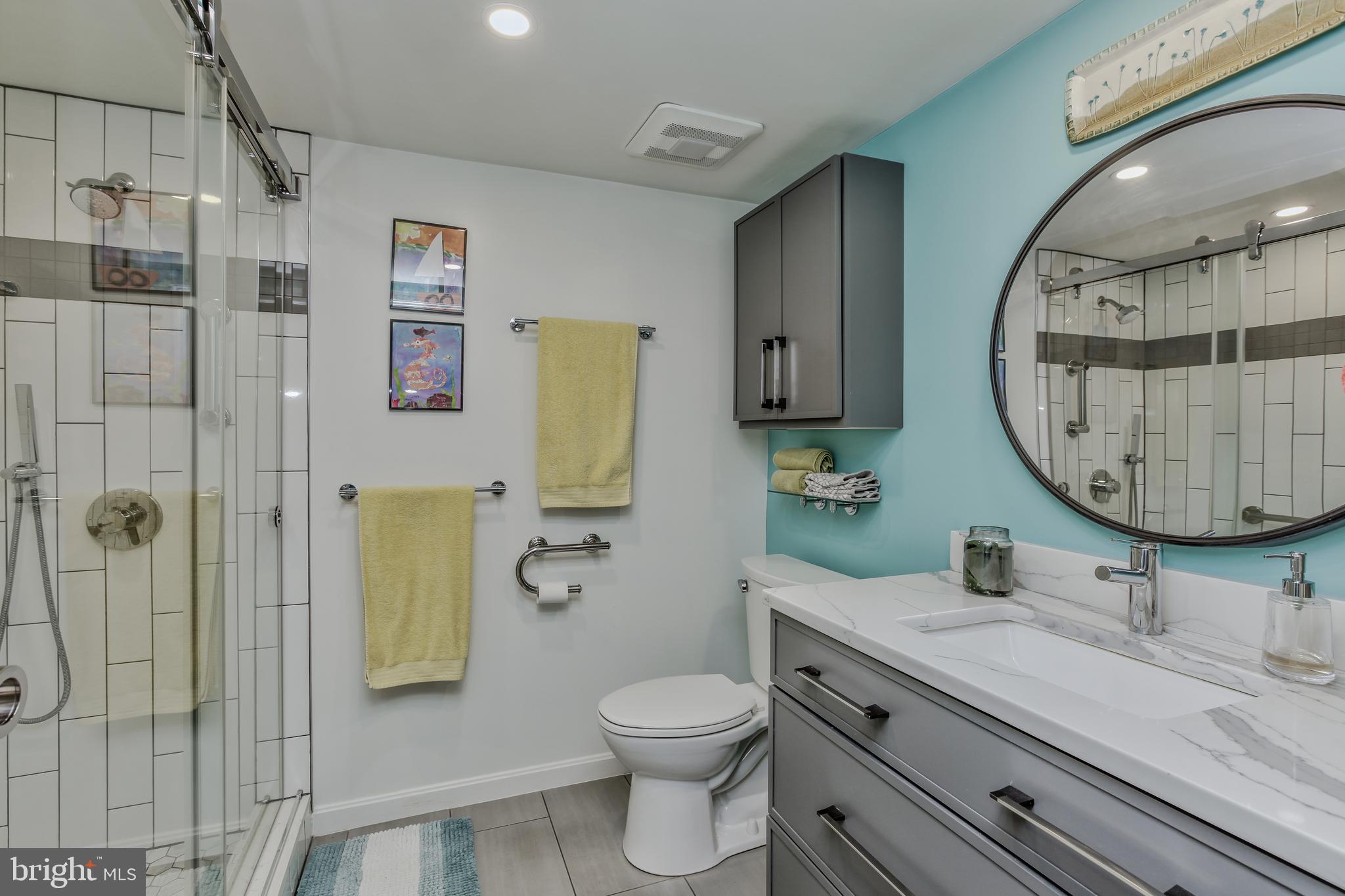 11710 Old Georgetown Road, Unit 422 North Bethesda, MD 20852 - Photo 17 of 28 a bathroom with a granite countertop toilet sink and mirror