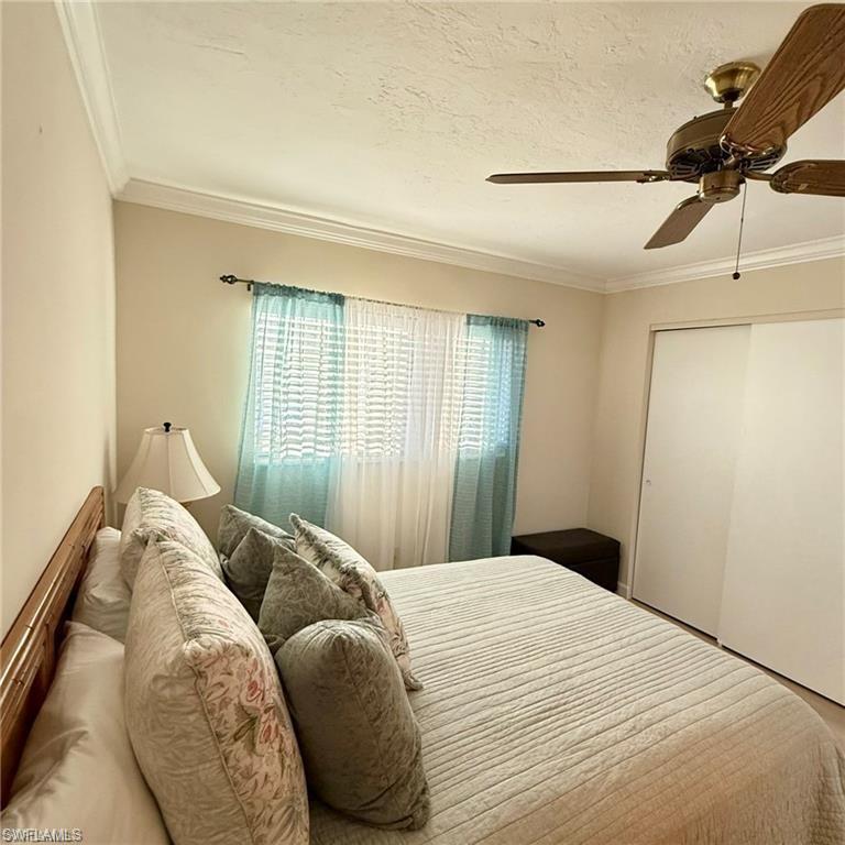 57 High Point Circle West, Unit 201 Naples, FL 34103 - Photo 13 of 18 a bedroom with a bed and a window
