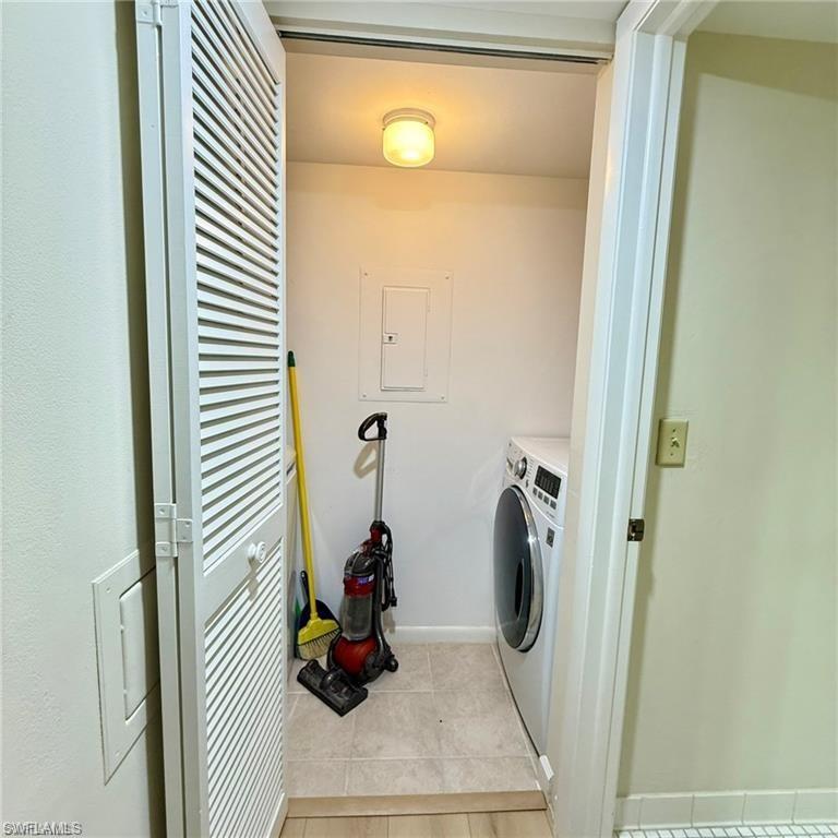 57 High Point Circle West, Unit 201 Naples, FL 34103 - Photo 14 of 18 a view of a storage and utility room with washer and dryer