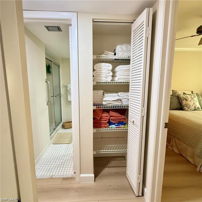 57 High Point Circle West, Unit 201 Naples, FL 34103 - Photo 15 of 18 a view of a bedroom from a hallway