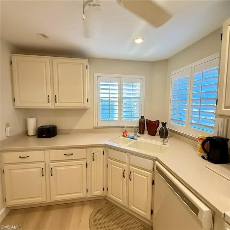 57 High Point Circle West, Unit 201 Naples, FL 34103 - Photo 18 of 18 a kitchen with a sink and cabinets
