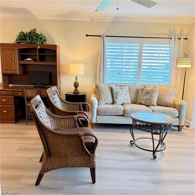 57 High Point Circle West, Unit 201 Naples, FL 34103 - Photo 5 of 18 a living room with furniture and a fireplace