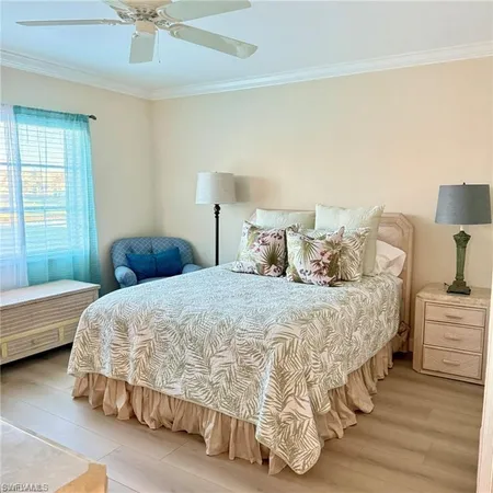 a bedroom with a bed and a ceiling fan