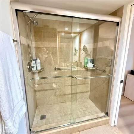 a bathroom with a glass shower door