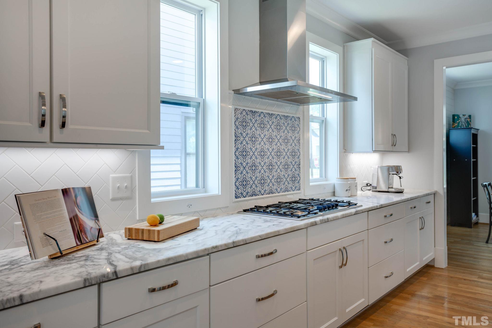 1702 Bickett Boulevard Raleigh, NC 27608 - Photo 11 of 41 a kitchen with granite countertop a sink stainless steel appliances white cabinets and a window