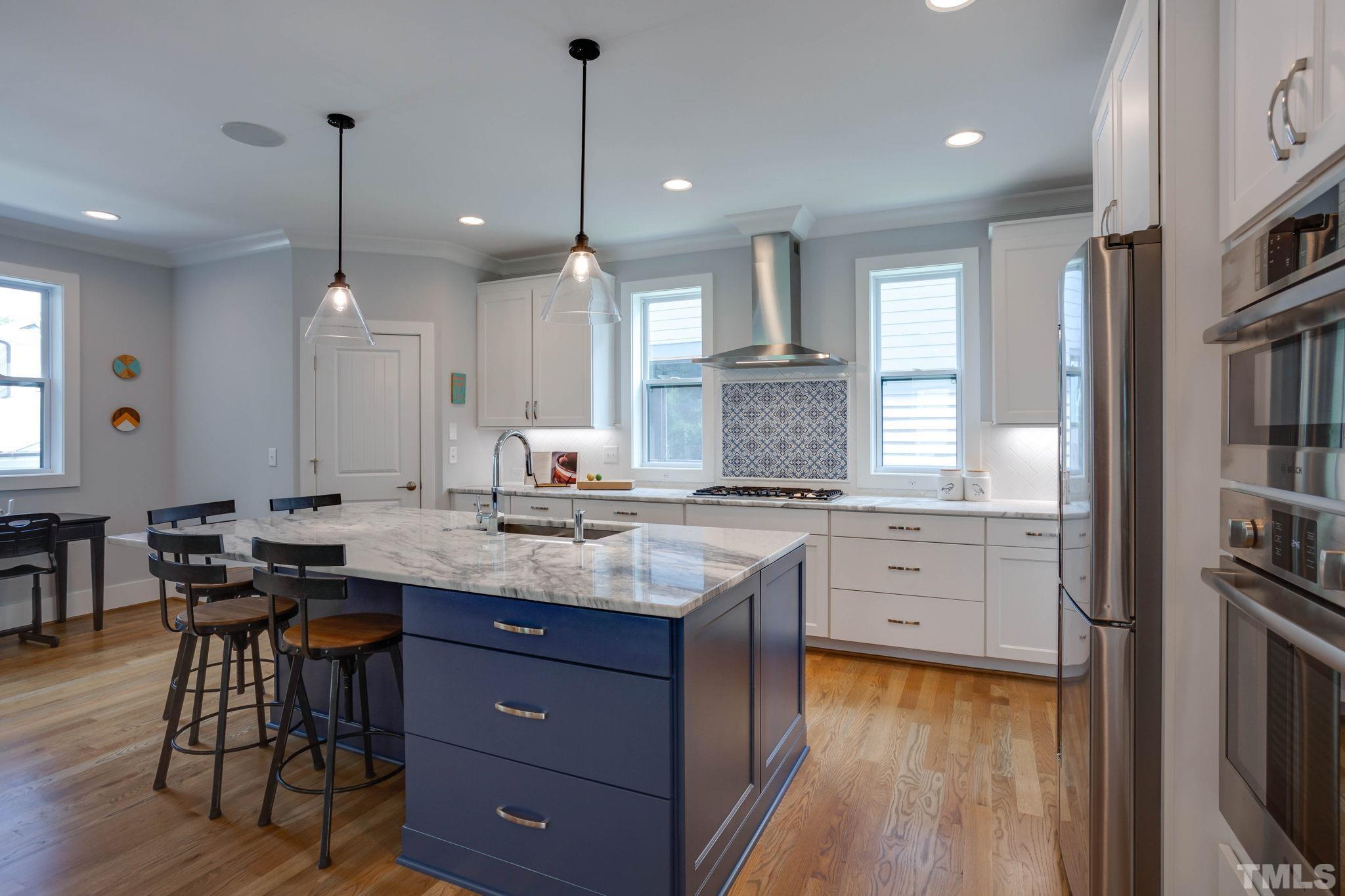 1702 Bickett Boulevard Raleigh, NC 27608 - Photo 12 of 41 a kitchen with granite countertop a stove a sink a dining table and chairs