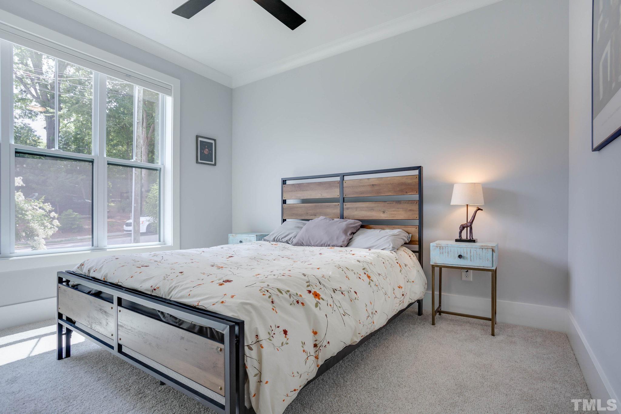 1702 Bickett Boulevard Raleigh, NC 27608 - Photo 19 of 41 a bedroom with a bed and a night stand