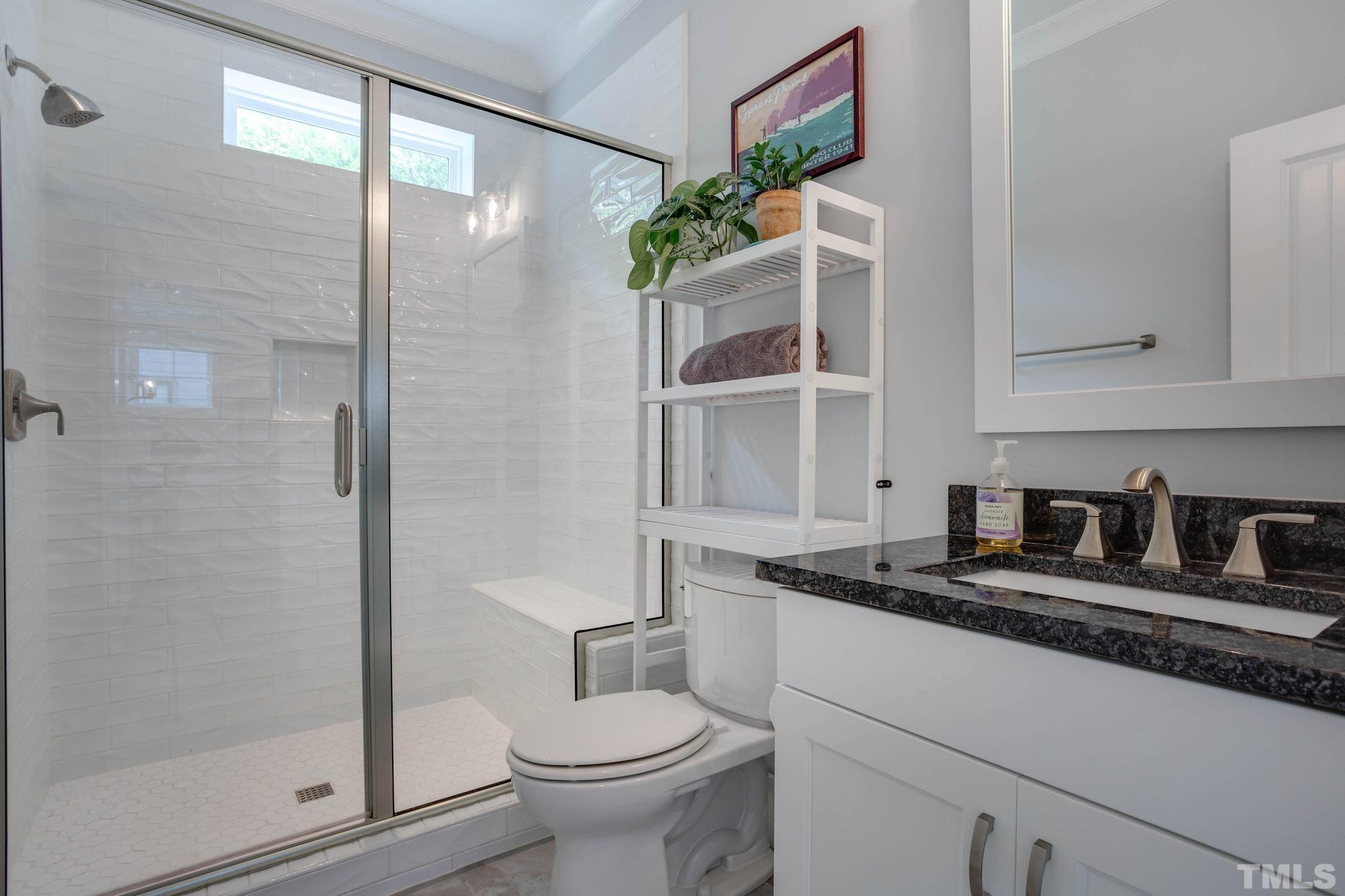 1702 Bickett Boulevard Raleigh, NC 27608 - Photo 20 of 41 a bathroom with a granite countertop sink mirror vanity and toilet