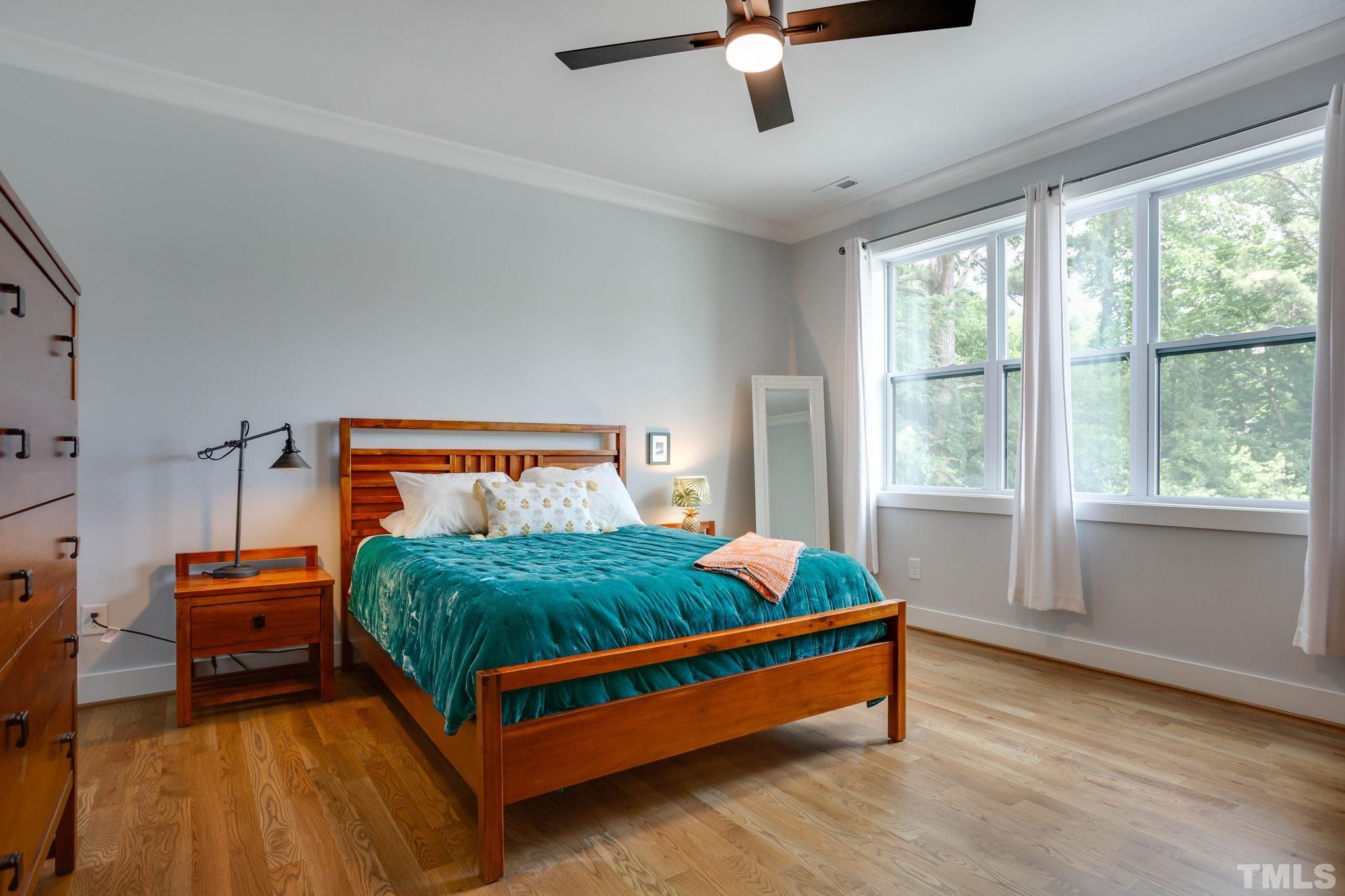 1702 Bickett Boulevard Raleigh, NC 27608 - Photo 21 of 41 a bed sitting in a bedroom next to a window