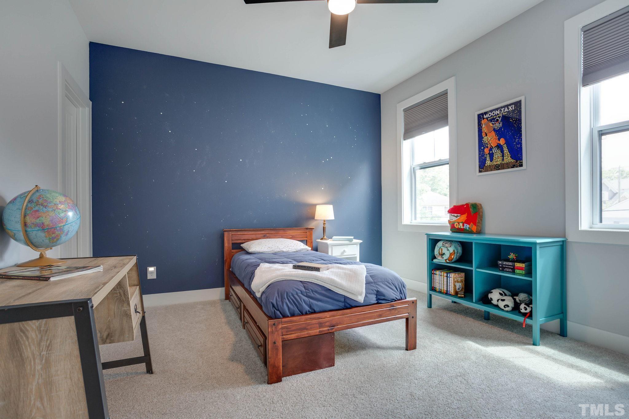 1702 Bickett Boulevard Raleigh, NC 27608 - Photo 24 of 41 a bedroom with a bed and a chandelier
