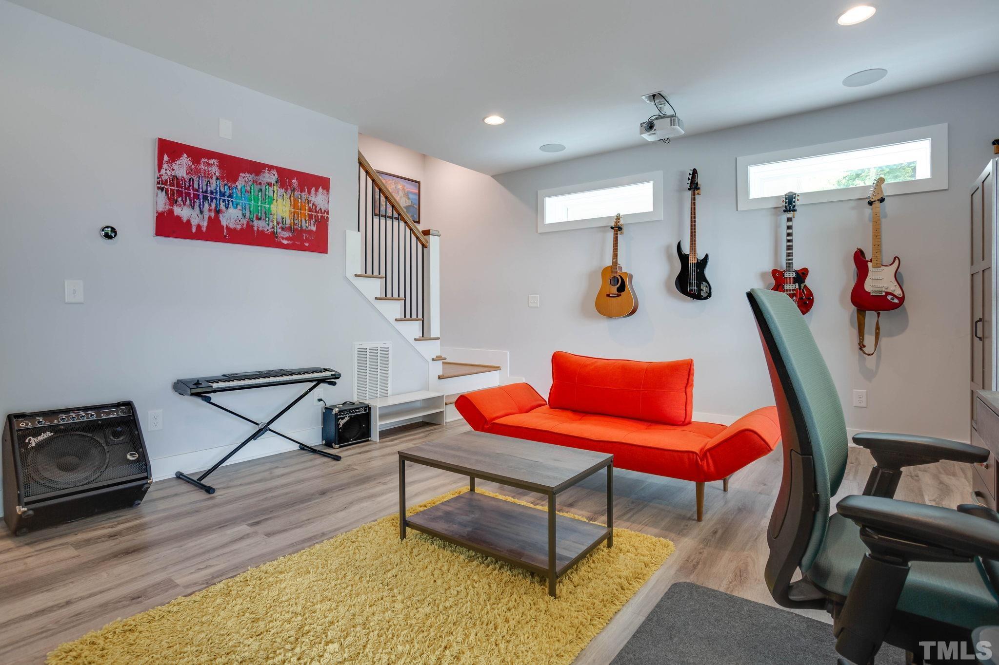 1702 Bickett Boulevard Raleigh, NC 27608 - Photo 28 of 41 a living room with furniture and a wooden floor