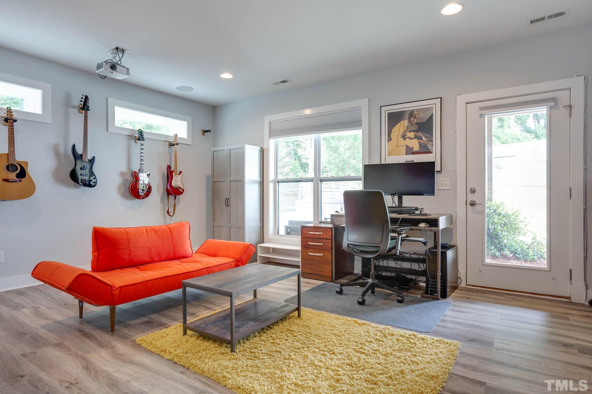 1702 Bickett Boulevard Raleigh, NC 27608 - Photo 30 of 41 a living room with furniture a rug and a window