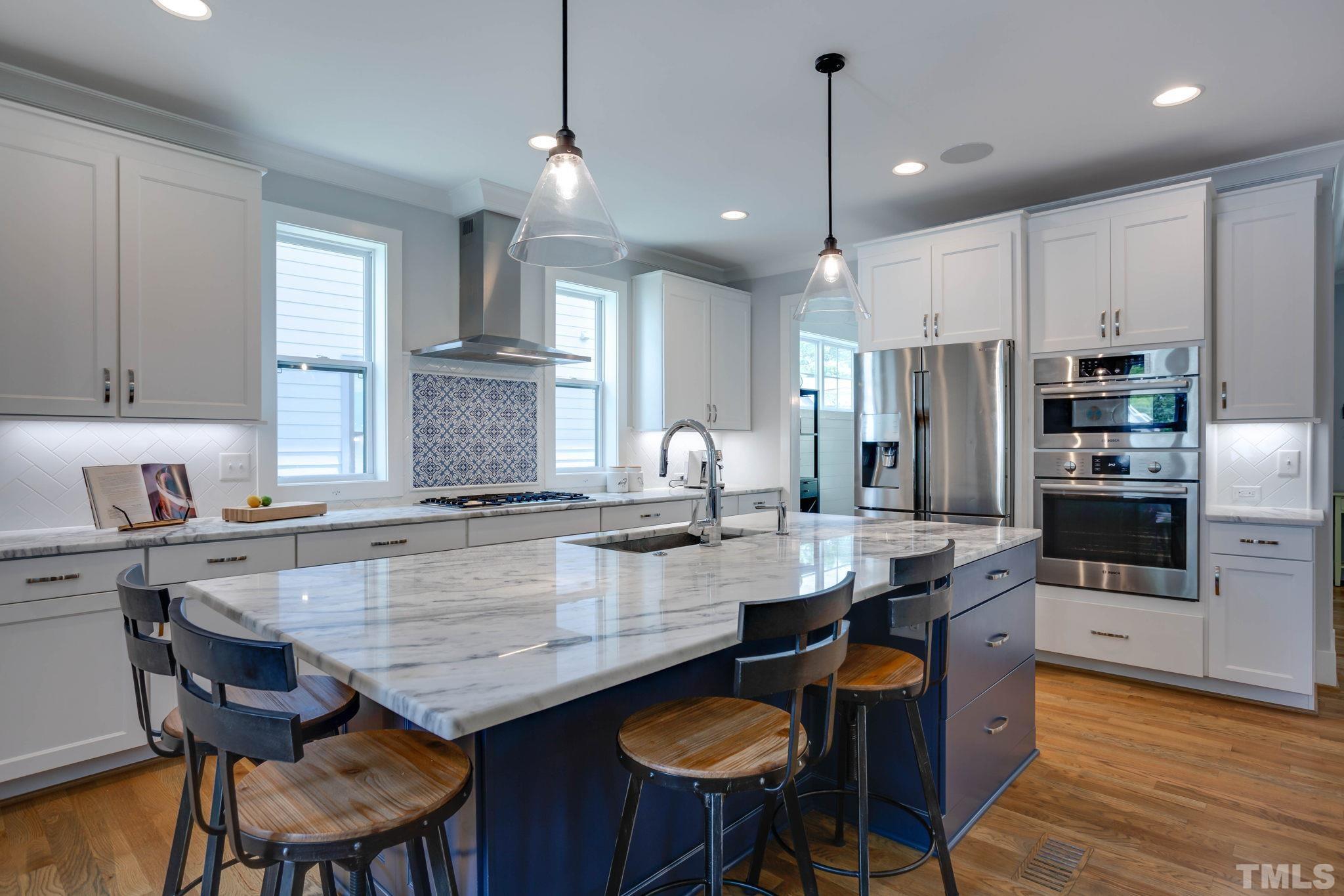 1702 Bickett Boulevard Raleigh, NC 27608 - Photo 7 of 41 a kitchen with granite countertop a table chairs stainless steel appliances and cabinets