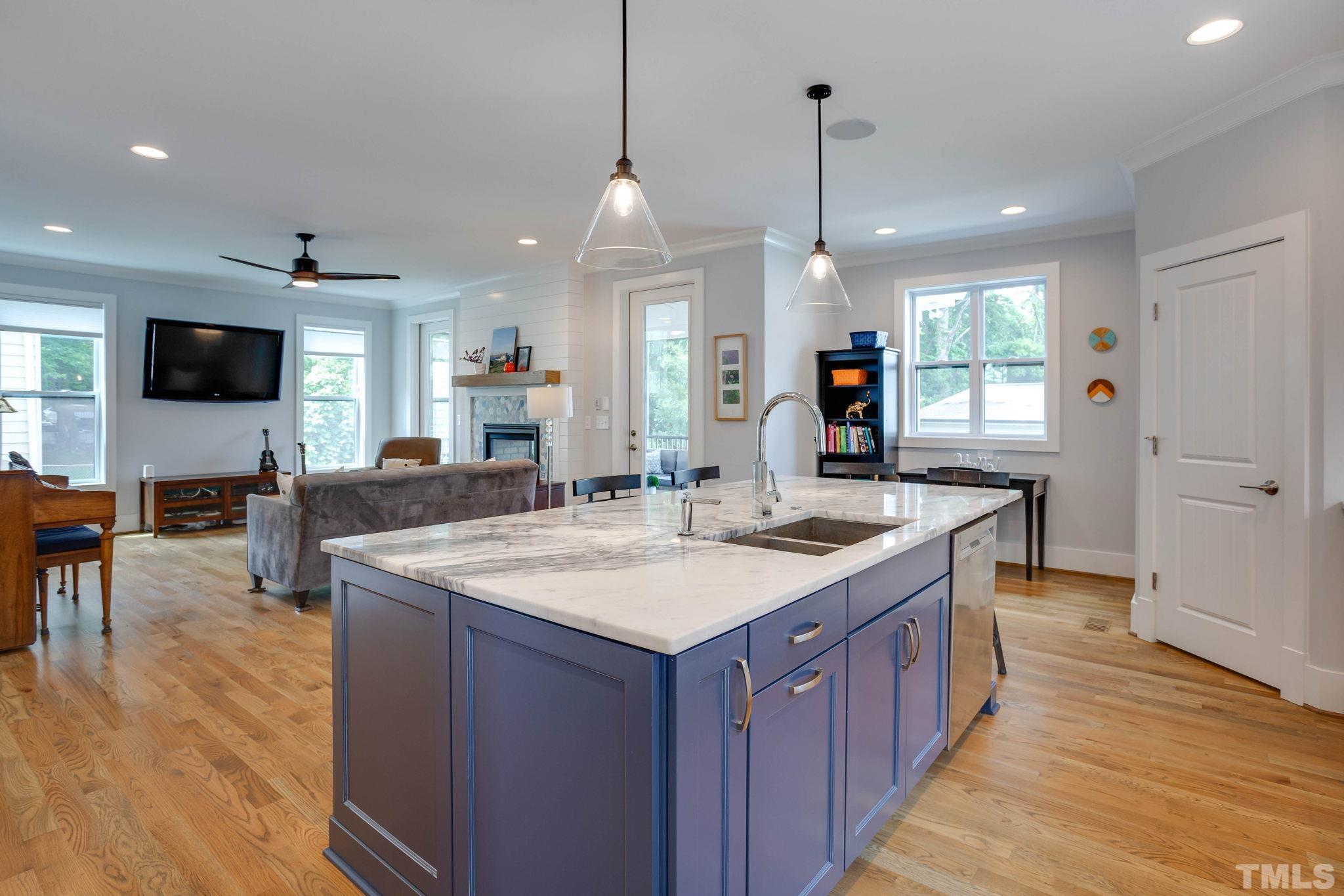 1702 Bickett Boulevard Raleigh, NC 27608 - Photo 8 of 41 a large kitchen with kitchen island a sink table and chairs