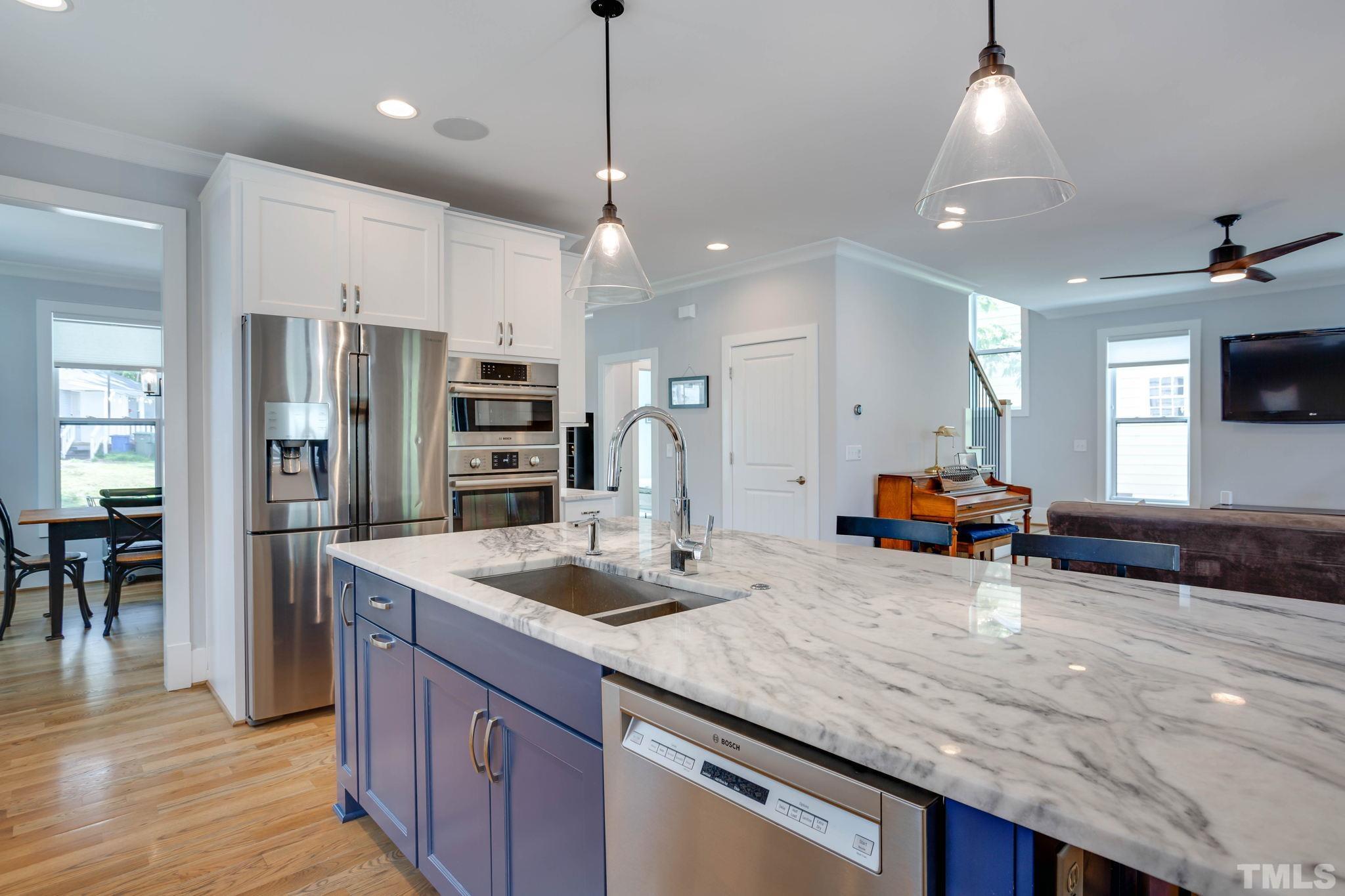 1702 Bickett Boulevard Raleigh, NC 27608 - Photo 9 of 41 a kitchen with stainless steel appliances granite countertop a sink a stove and a refrigerator