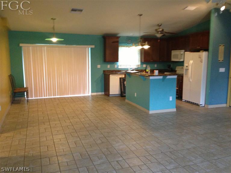 348 Rancho Avenue Lehigh Acres, FL 33974 - Photo 3 of 10 a view of kitchen with refrigerator and cabinets