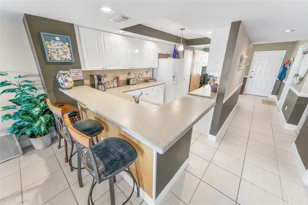 a room with furniture a rug and white walls