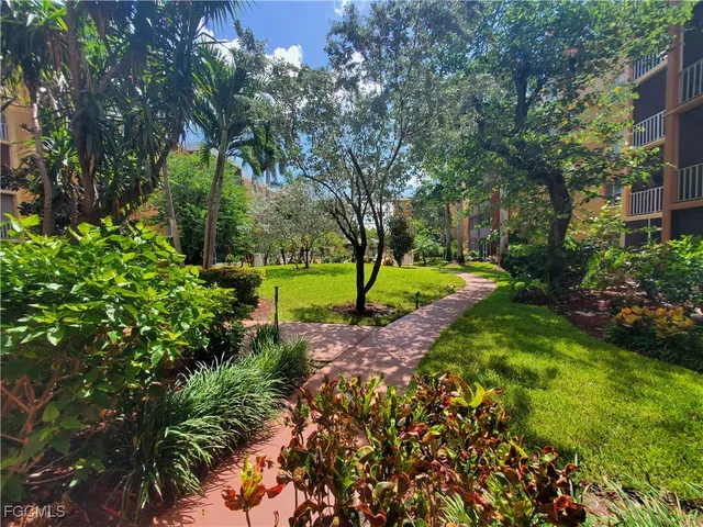 a kitchen with granite countertop a sink and cabinets