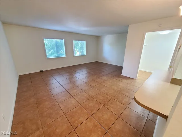 a view of a kitchen with furniture and an empty room