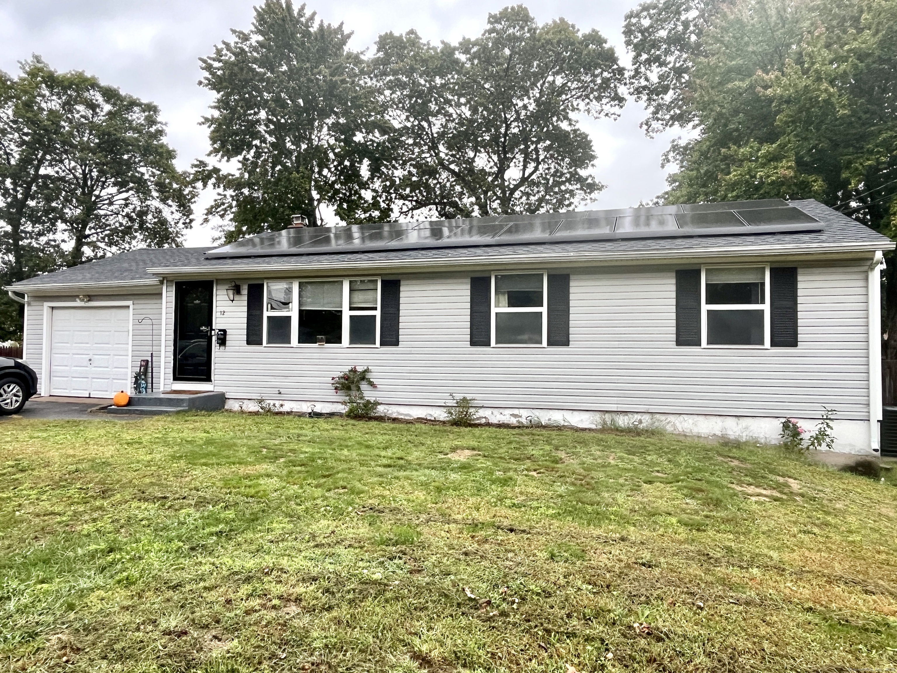 12 Post Road Enfield, CT 06082 - Photo 1 of 15 a backyard of a house with table and chairs