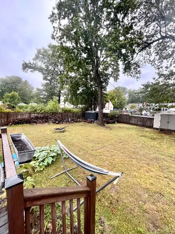a view of yard with swimming pool and trees