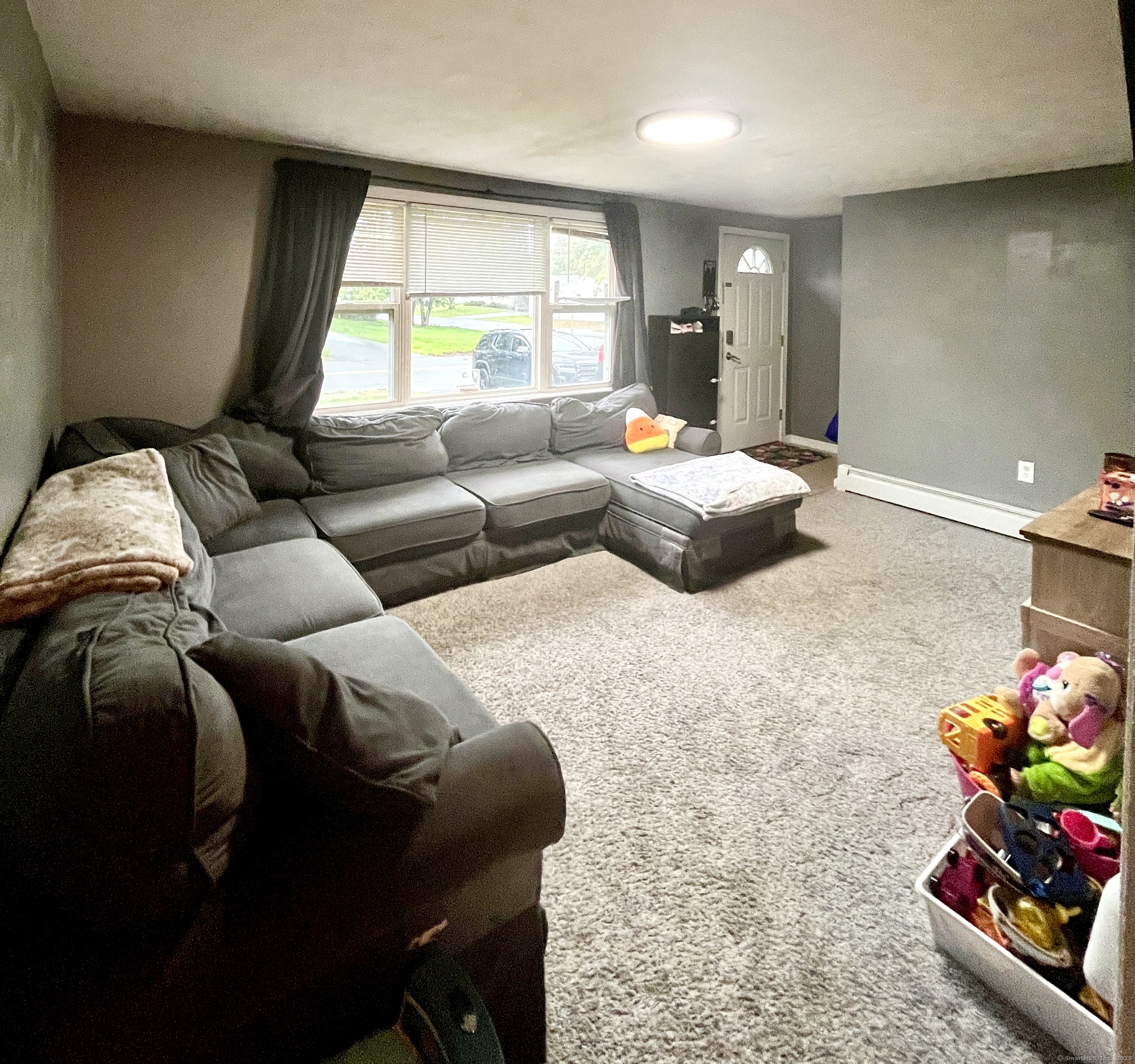 12 Post Road Enfield, CT 06082 - Photo 2 of 15 a bedroom with a bed and a couch