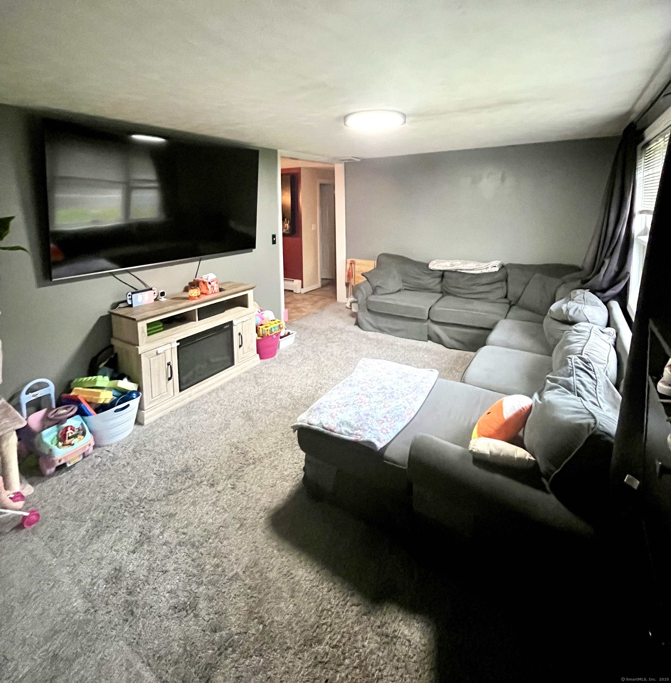 12 Post Road Enfield, CT 06082 - Photo 3 of 15 a living room with furniture and a flat screen tv