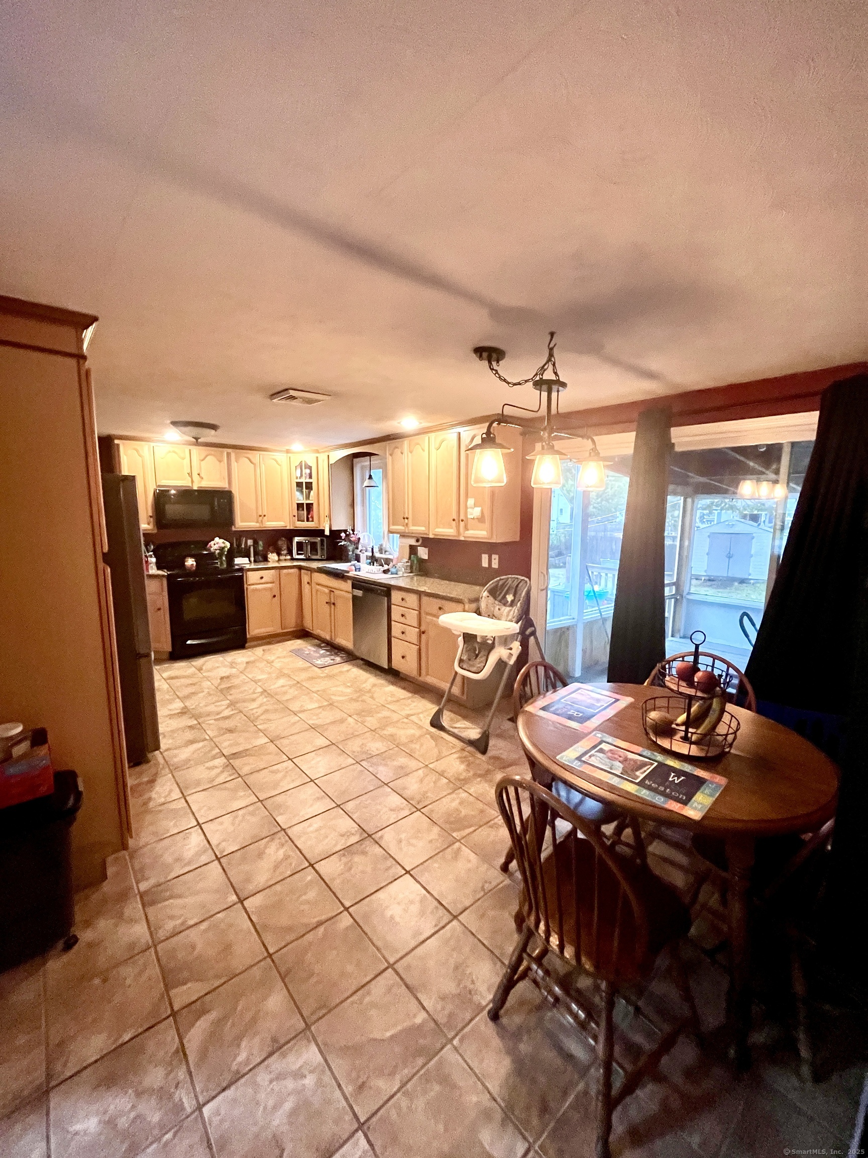 12 Post Road Enfield, CT 06082 - Photo 5 of 15 a kitchen with stainless steel appliances kitchen island granite countertop a table chairs and a refrigerator
