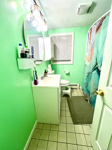 a room with sink mirror and furniture