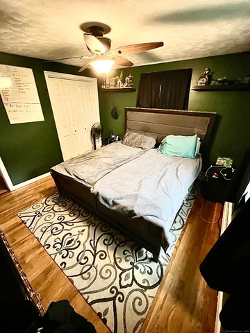 a bedroom with a bed and mirror
