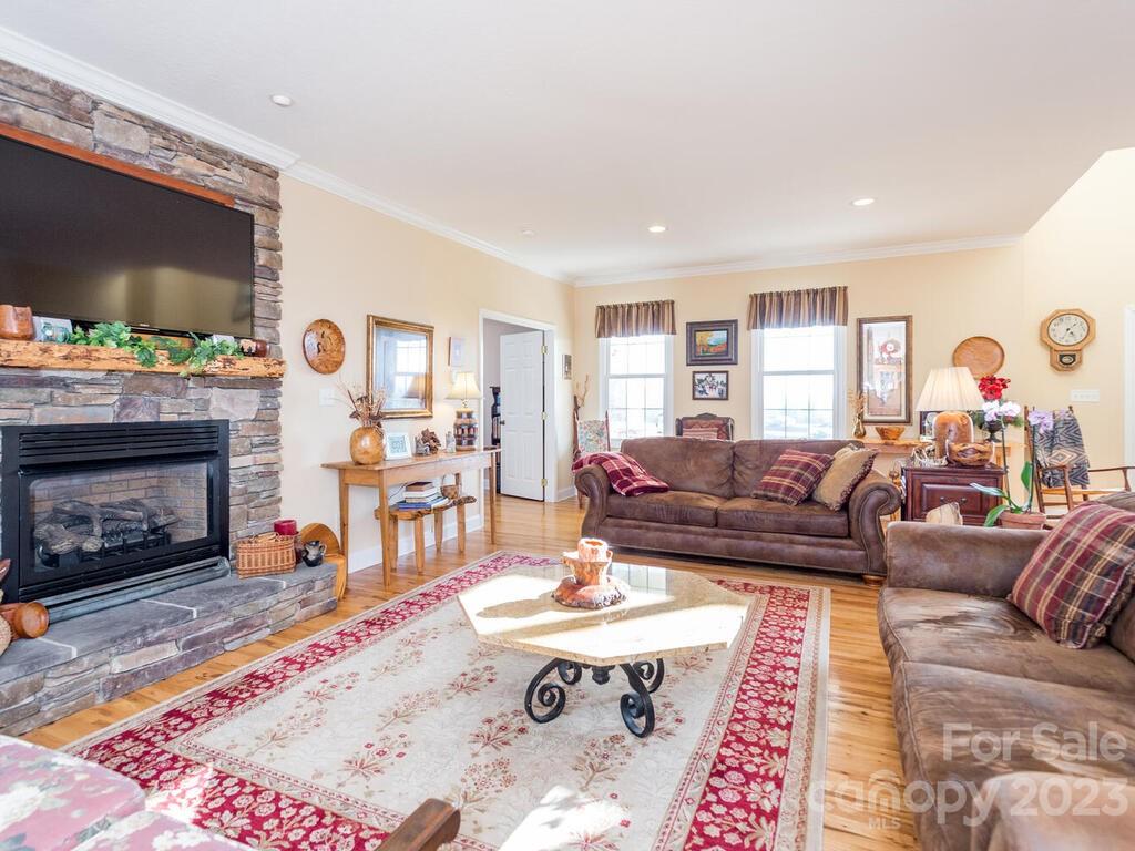 264 Hazel Brook Road Marshall, NC 28753 - Photo 17 of 47 a living room with furniture a flat screen tv and a fireplace