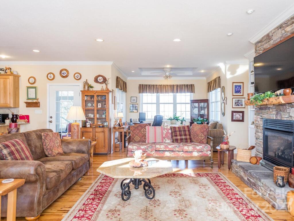 264 Hazel Brook Road Marshall, NC 28753 - Photo 18 of 47 a living room with fireplace furniture and a flat screen tv