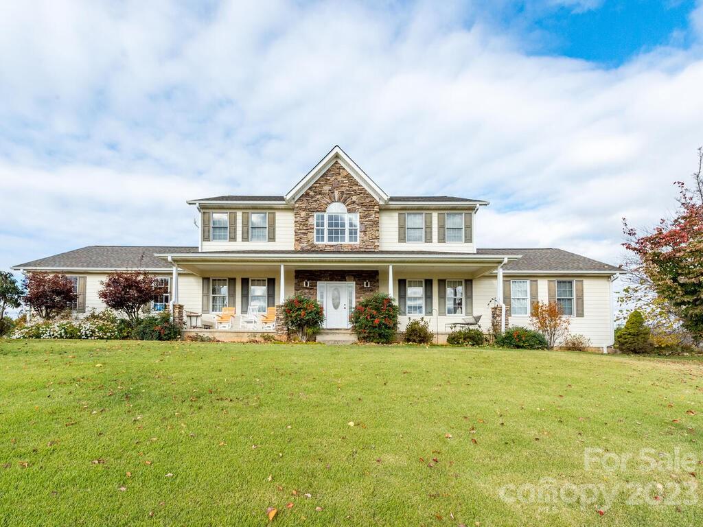 264 Hazel Brook Road Marshall, NC 28753 - Photo 2 of 47 a front view of a house with a yard