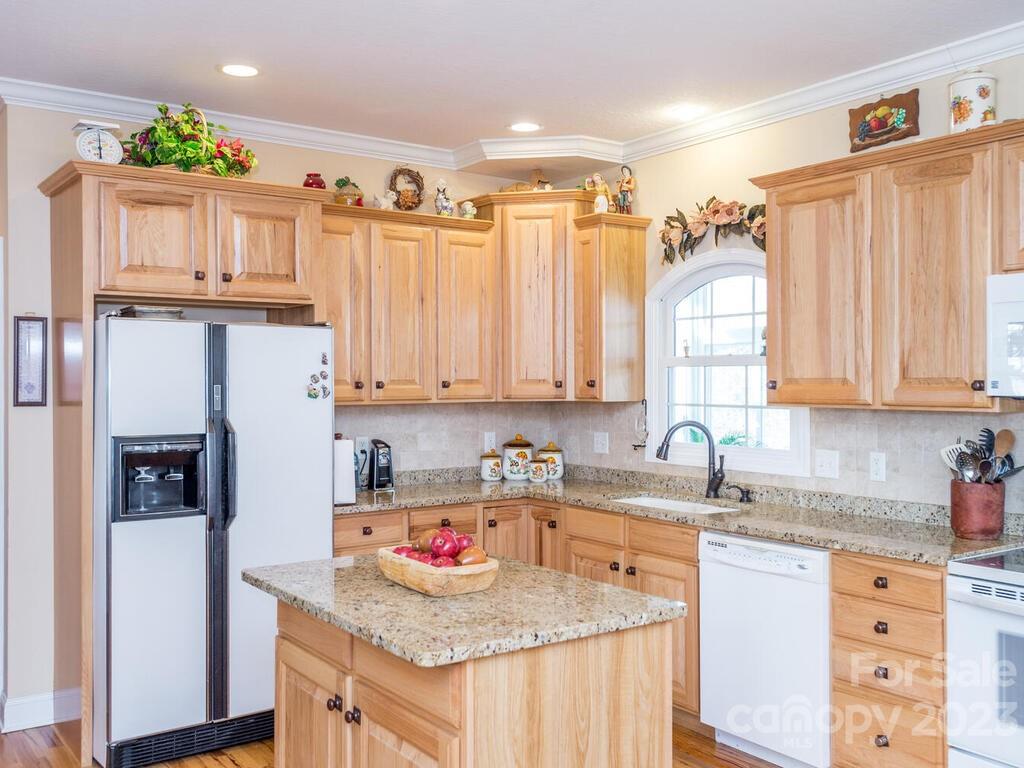264 Hazel Brook Road Marshall, NC 28753 - Photo 23 of 47 a kitchen with stainless steel appliances granite countertop a sink refrigerator and cabinets