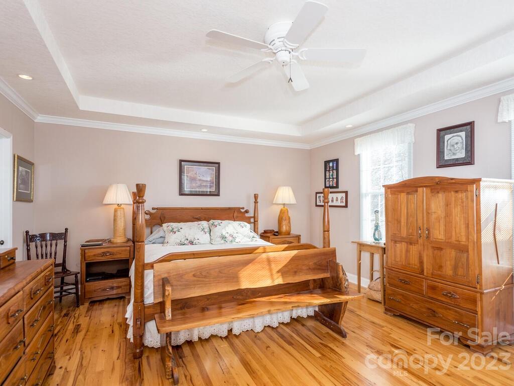 264 Hazel Brook Road Marshall, NC 28753 - Photo 24 of 47 a bedroom with a bed and wooden floor