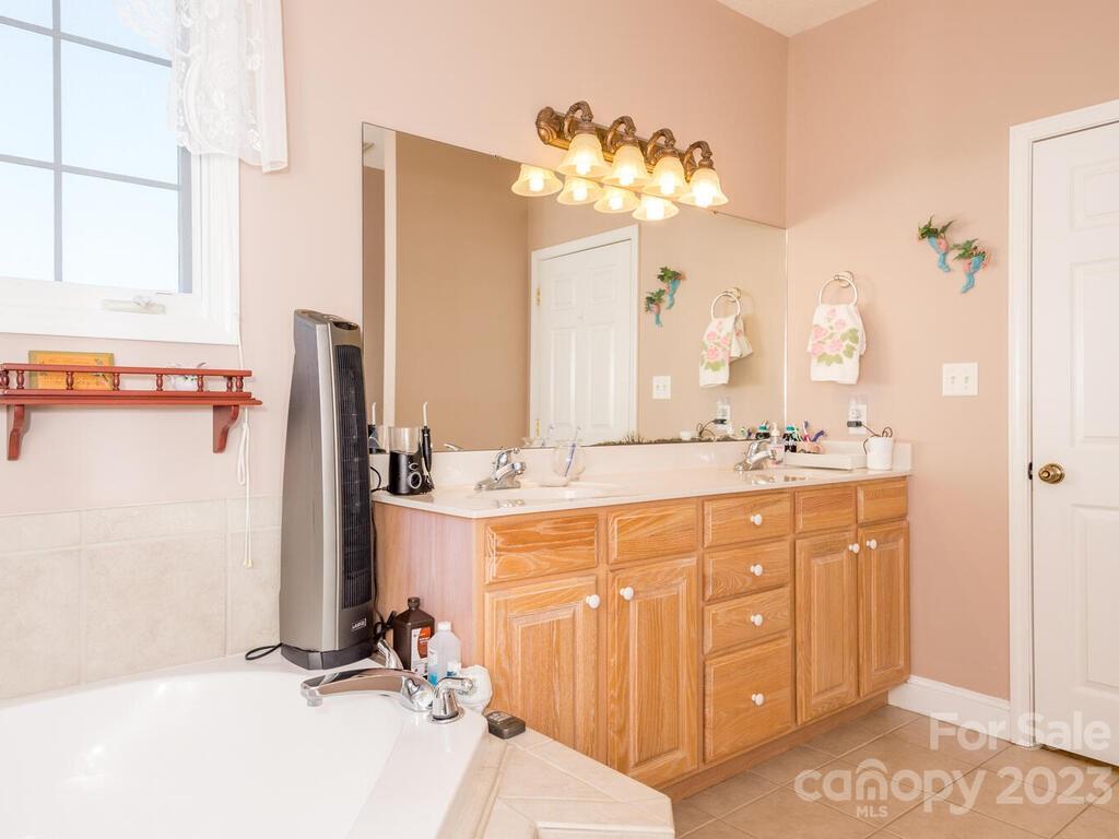 264 Hazel Brook Road Marshall, NC 28753 - Photo 25 of 47 a bathroom with a double vanity sink mirror and double