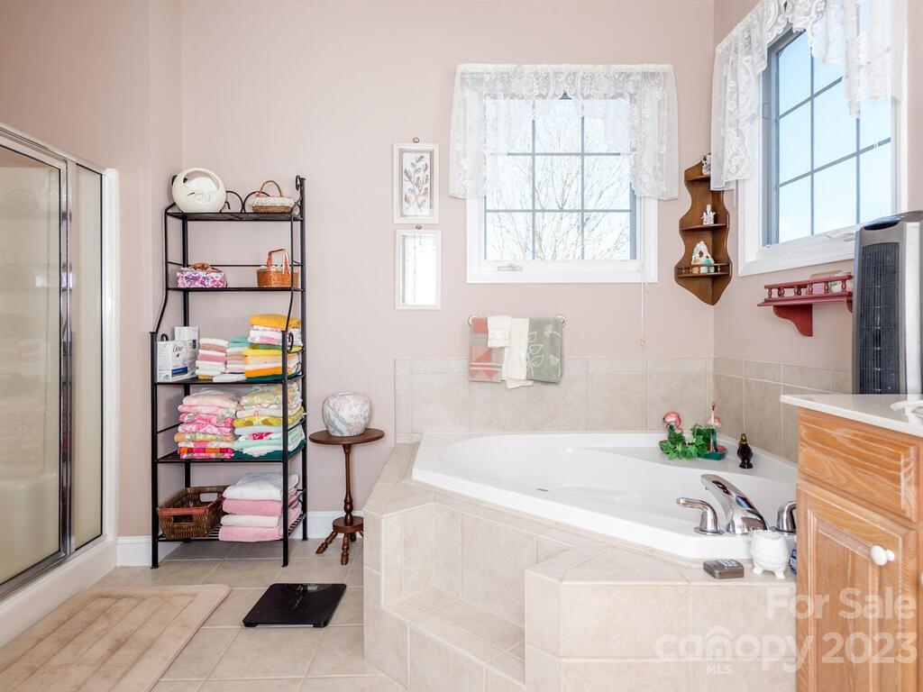 264 Hazel Brook Road Marshall, NC 28753 - Photo 26 of 47 a bathroom with a tub and a window