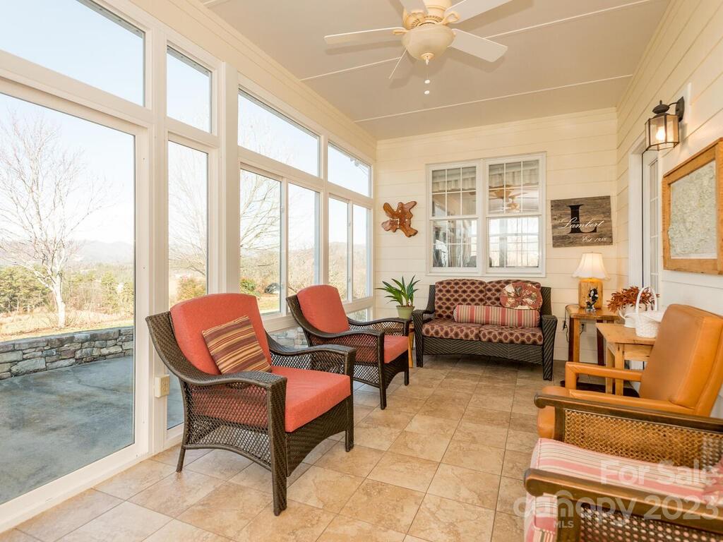 264 Hazel Brook Road Marshall, NC 28753 - Photo 27 of 47 a living room with furniture and a floor to ceiling window