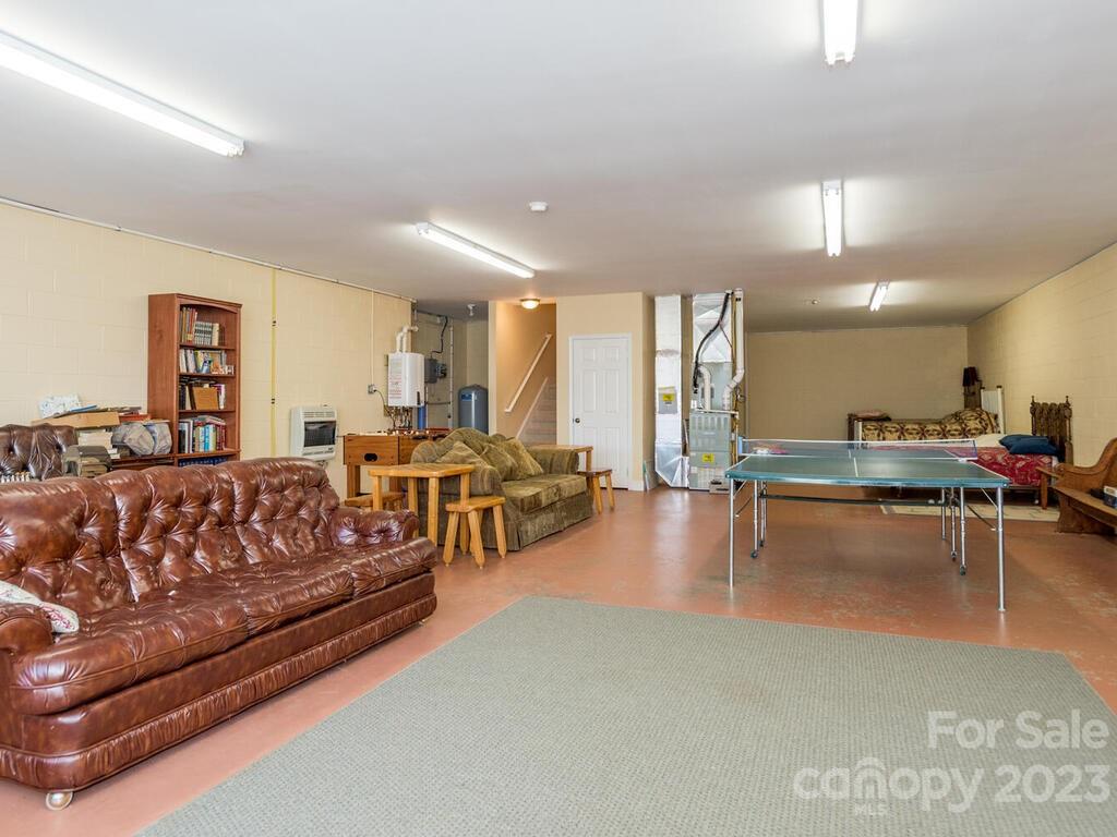 264 Hazel Brook Road Marshall, NC 28753 - Photo 36 of 47 a living room with furniture and a table